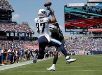 Football player in action with a large screen displaying game information in the background and being shown with IPTV UK